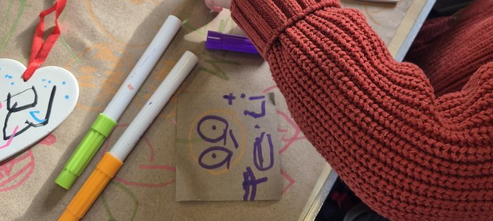 child taking part in a ceramic heart activity