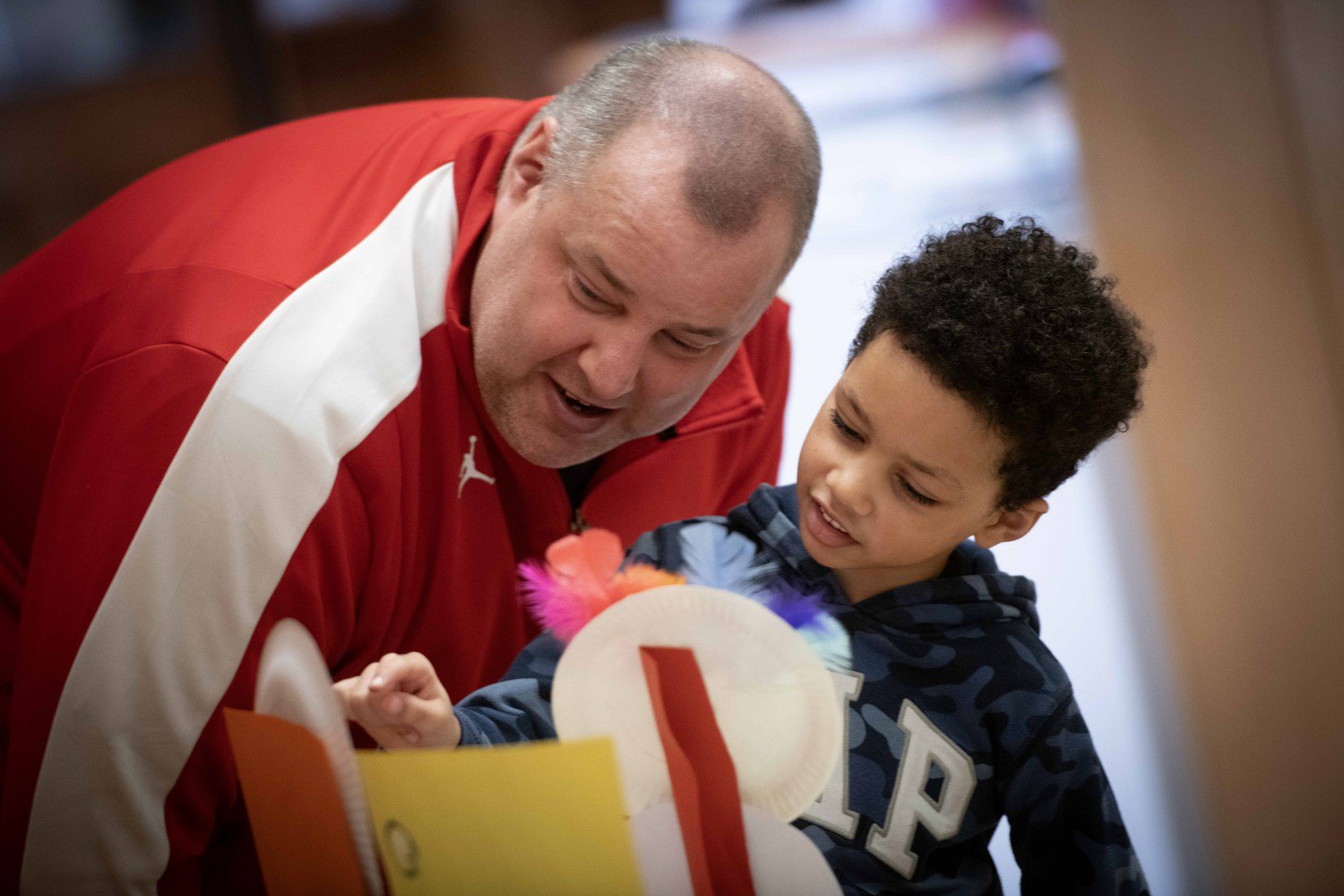 A man and child are looking at craft materials A man and child are looking at craft materials