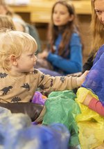 Toddlers at a play station with tactile items