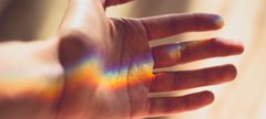 hand with rainbow light landing on the palm