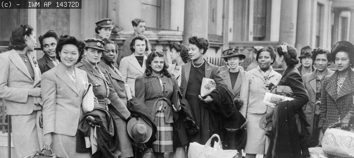 A group of West Indian women recruited to join the ATS, wait for transport to take them to their train© IWM AP 14372D