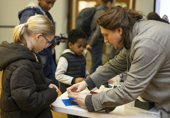Children learning from an adult 