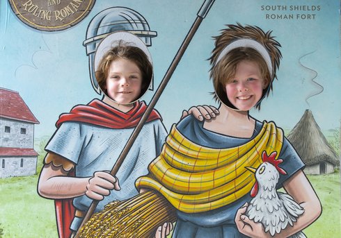 Heads of two children showing through pop up stand