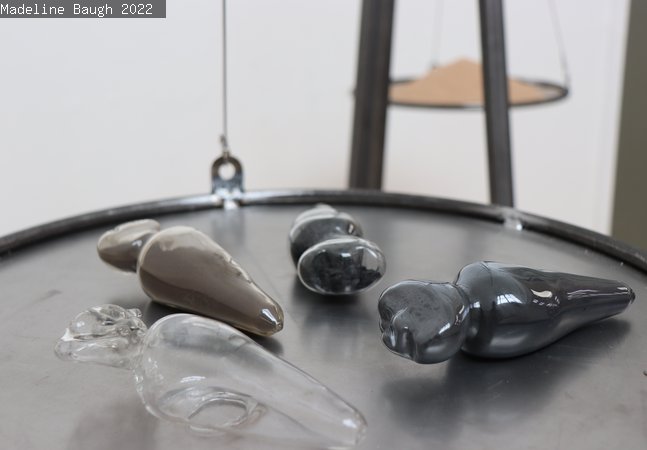 Small glass sculptures on a metal tray