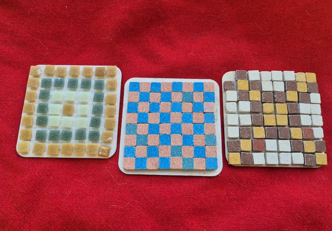 3 Mosaic coasters on a red background