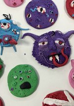 Different shaped, colourful monsters made out of clay.