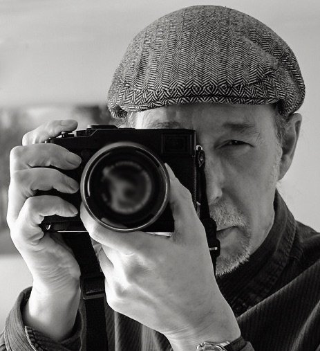 Man holding camera and looking in viewfinder 