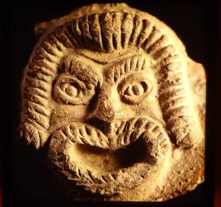 Pottery lamp detail showing a theatrical mask