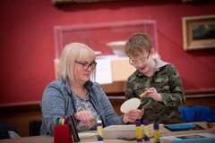 A photograph of a mum and child doing crafts together.