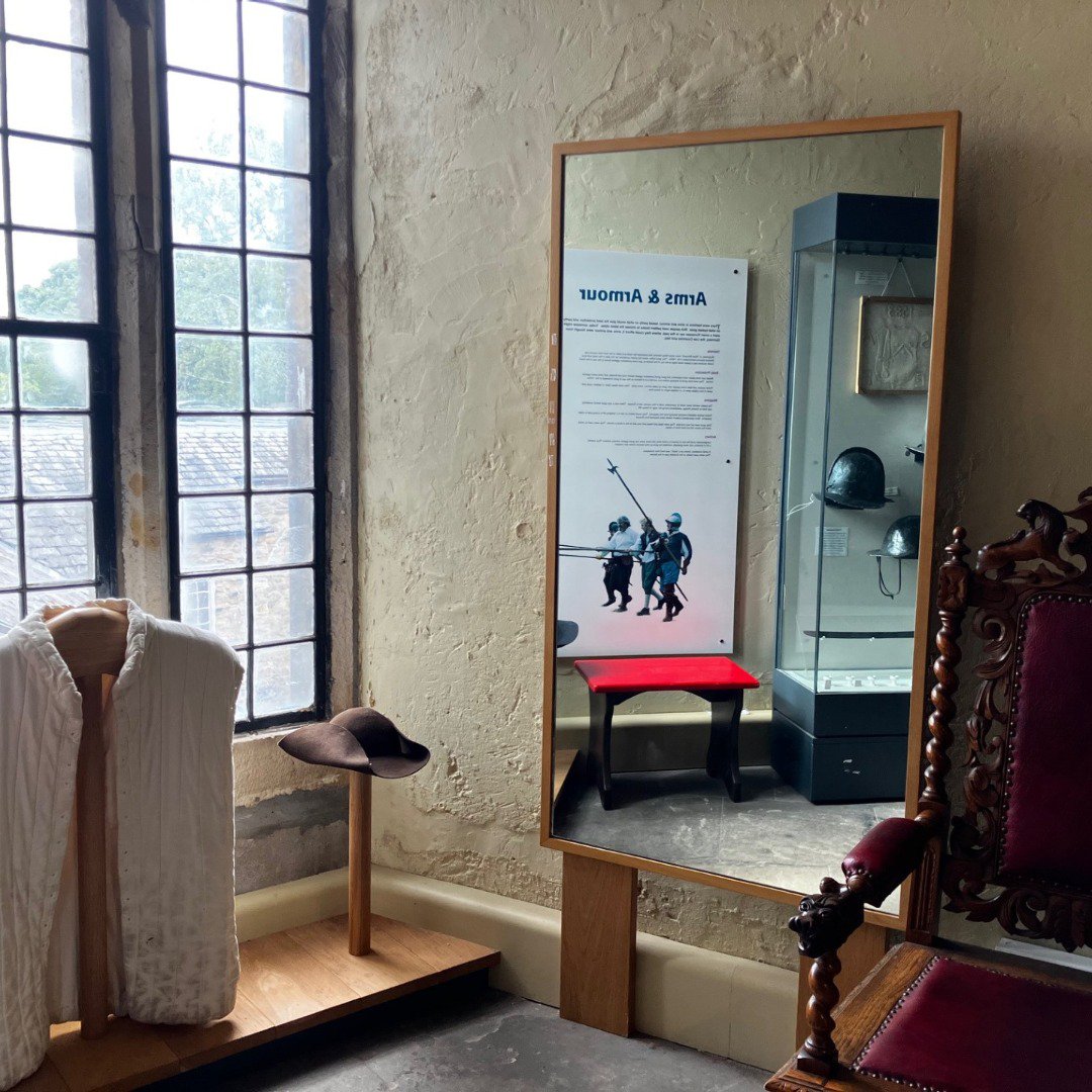 Dress up section of a museum with a mirror Dress up section of a museum with a mirror
