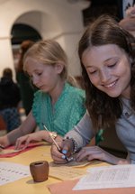 Two girls in Roman Gallery taking part in a writing activity expirers 