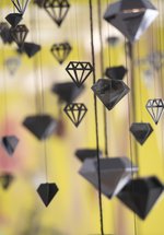Black diamonds of paper and card hanging by threads