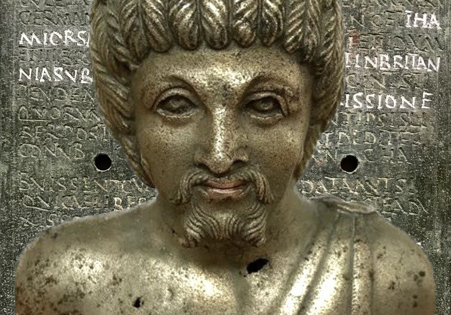 A metal vessel, designed in the shape of a male head and shoulders.