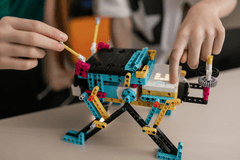 A photograph of a child making something out of legos.