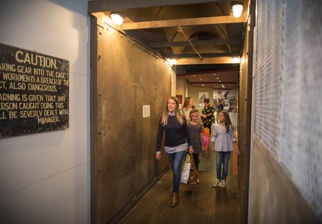 A family walk through a museum exhibition space