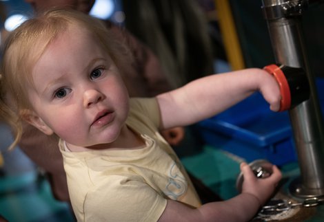 little girl plays in gallery