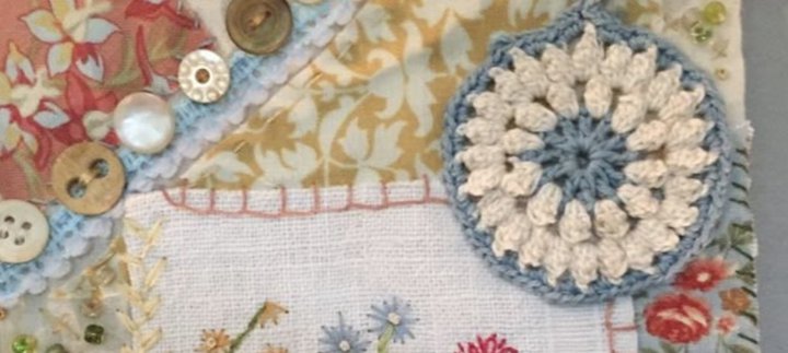 A variety of fabrics and button sewn together to form one piece of fabric.