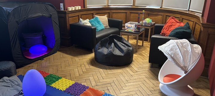 A room with comfy seating and a variety of toys.