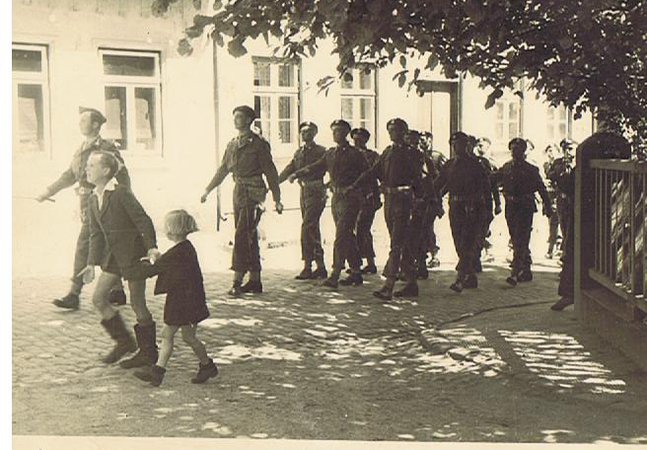 Tank crew of the 13th/18th Hussars celebrating victory with the local population, 1945