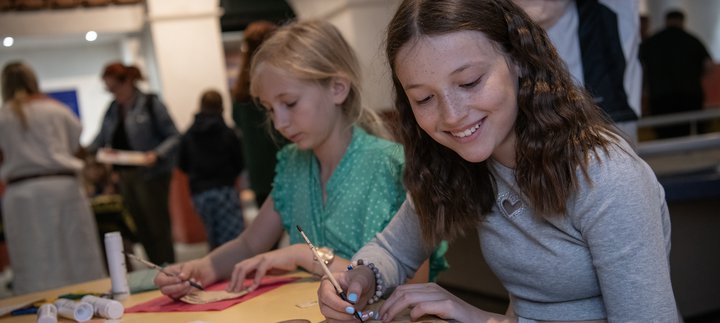 Two girls in Roman Gallery taking part in a writing activity expirers 