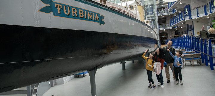 family in Discovery Museum look around