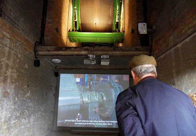 Man with hat looking at screen 
