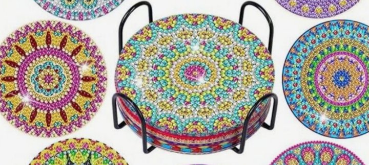 A set of decorated coasters in multi coloured gemstones.