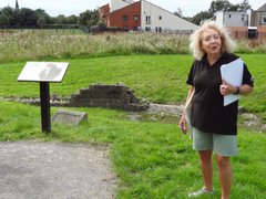 Woman standing near an information board