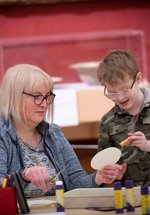 A photograph of a mum and child doing crafts together.