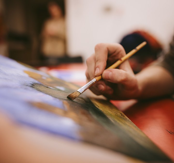 painting by a young boy holding a paintbrush