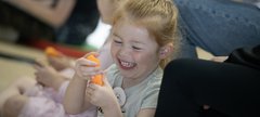 small girl smiling during activity with story 