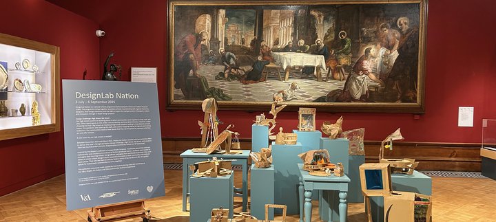 A display of cardboard artwork in a gallery space at the Shipley