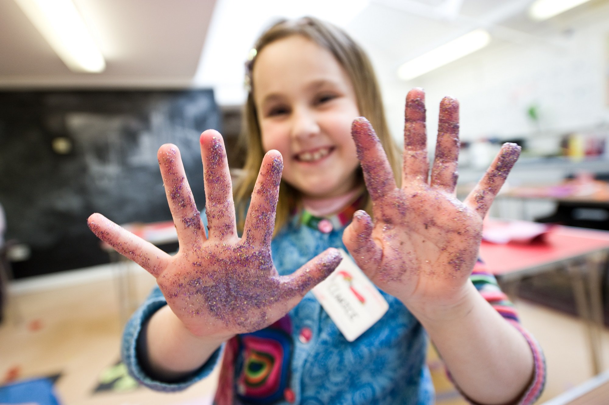 A girl with glitter on her hands shows them to the camera A girl with glitter on her hands shows them to the camera