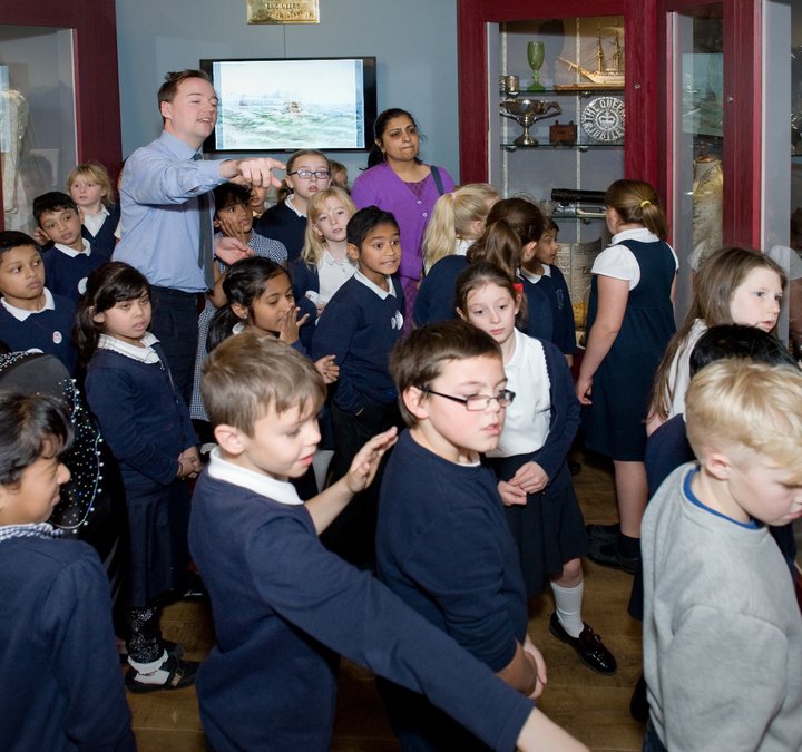 Adam Bell showing school children the gallery