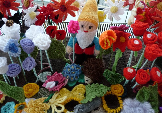 A knitted gnome and flowers