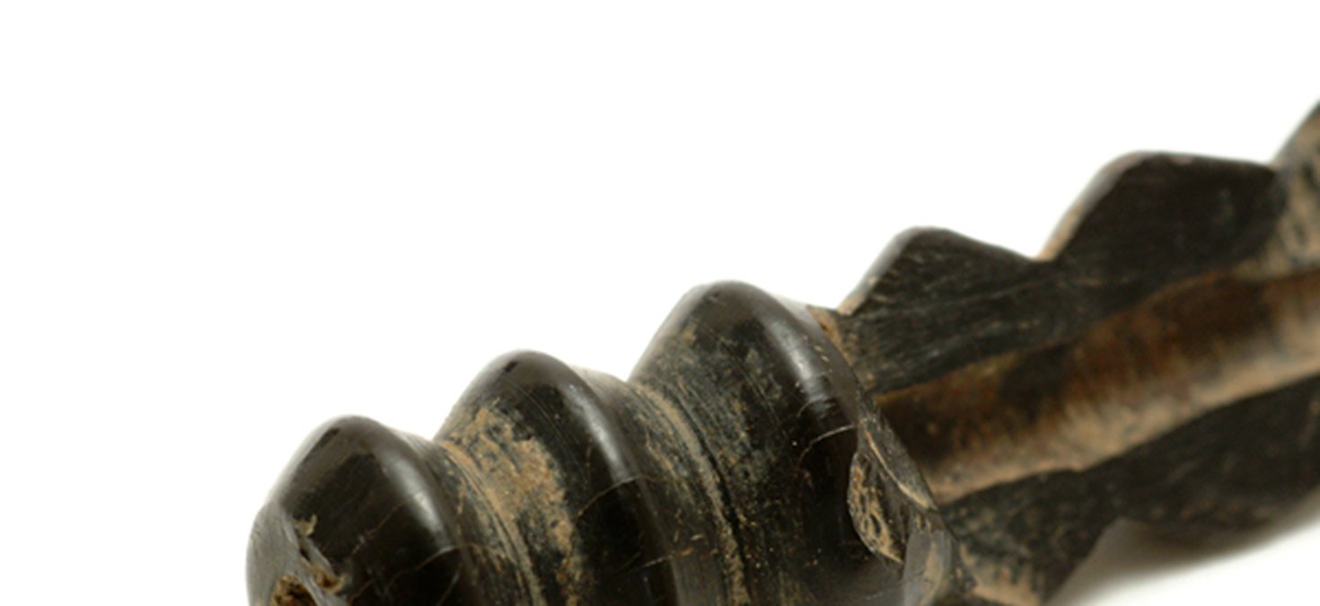 This broken jet bead reveals the hole, less than 2mm across, drilled down its length.