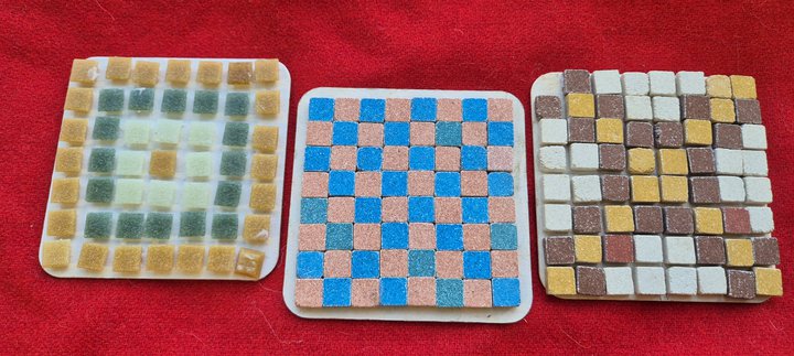 3 Mosaic coasters on a red background