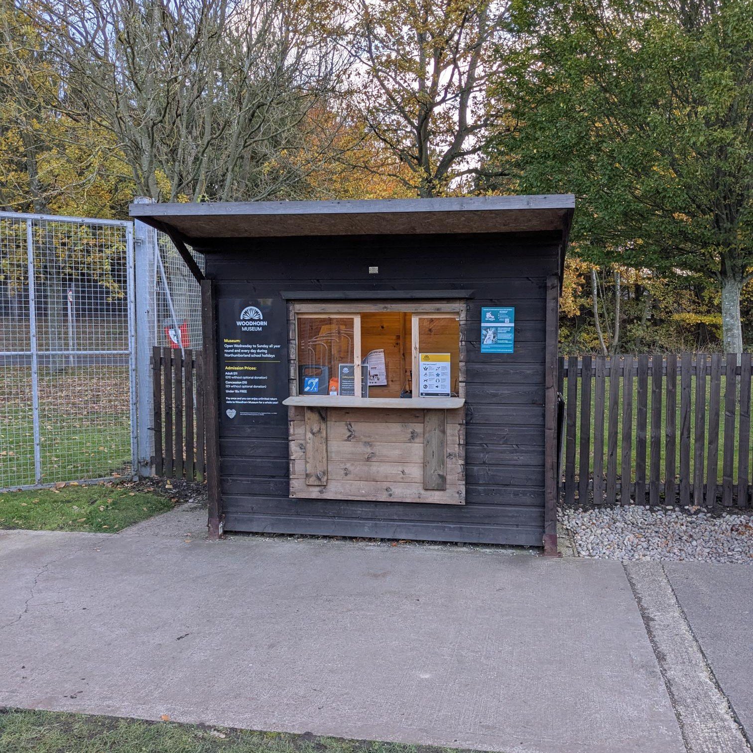 A wooden hut used for buying tickets at a museum.