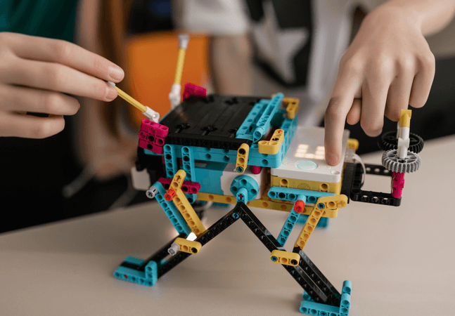 A photograph of a child making something out of legos.
