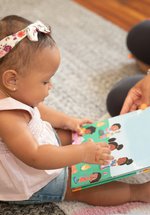  A baby holding a book