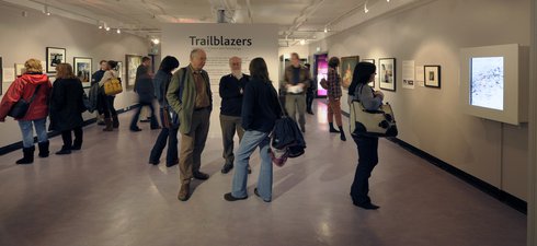 A number of people in the temporary gallery looking at the Trailblazers exhibition