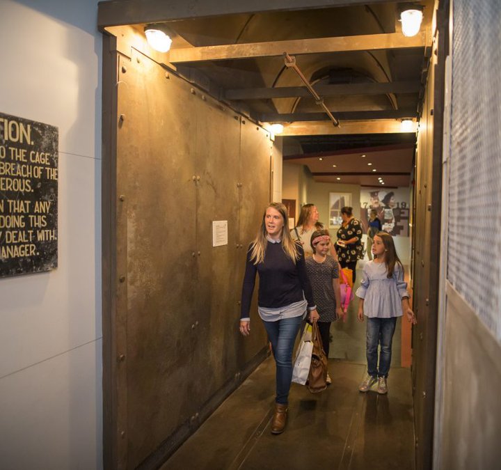 A family walk through a museum exhibition space