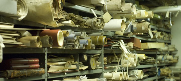 Photo of shelves of rolled up scrolls and papers