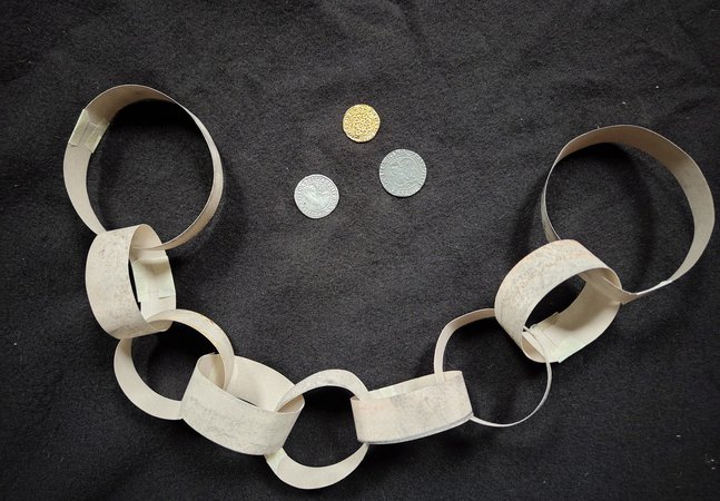 Paper manacles and coins 