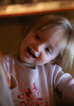 smiling young girl tilts head 