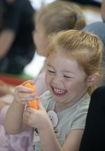 small girl smiling during activity with story 