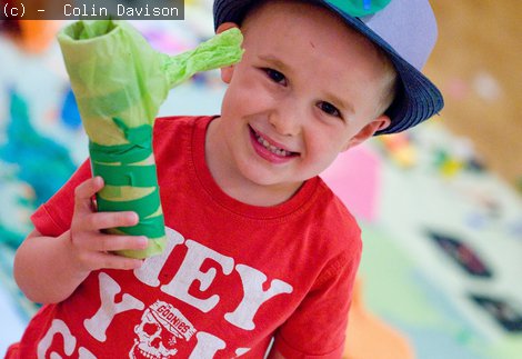 A boy holding his creation at a Big Wednesday event