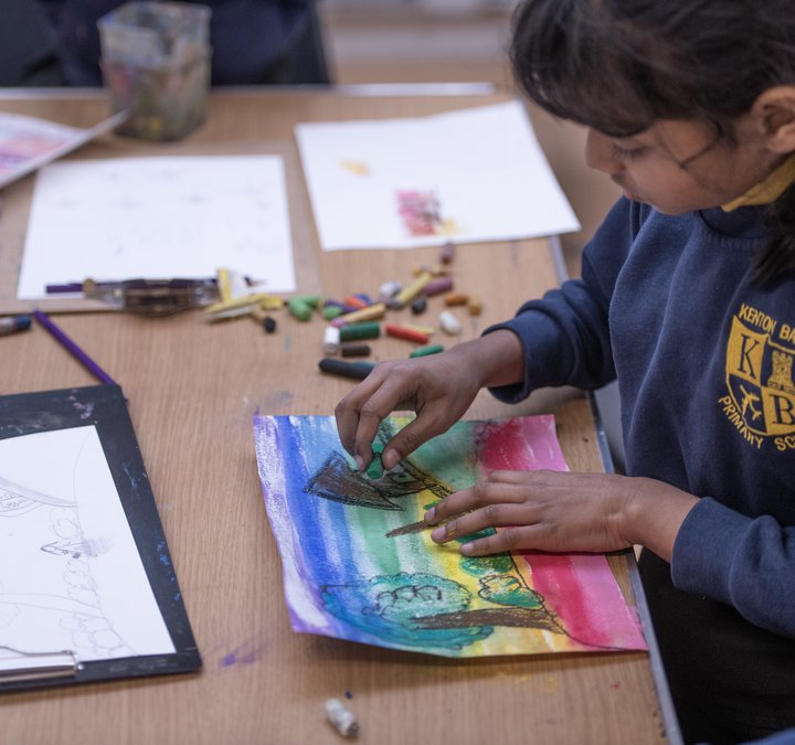 child making pastel drawing