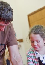 Dad and daughter engage in craft activity 