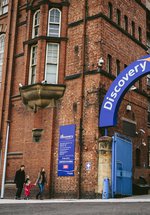 A family enter Discovery Museum 